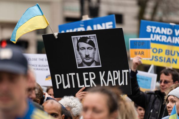March 6, 2022, Boston, Massachusetts, United States: A demonstrator holds a sign comparing Putin to Hitler in Boston..Demonstrators in Boston came together for a peaceful march through Downtown Boston standing with Ukraine. Boston Mayor Michelle Wu and US Representative Ayanna Pressley were both present during a vigil in the Boston Common. (Credit Image: © Vincent Ricci/SOPA Images via ZUMA Press Wire)