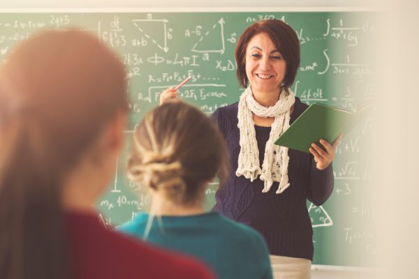 Teacher,Giving,Lesson,To,Students,In,Classroom