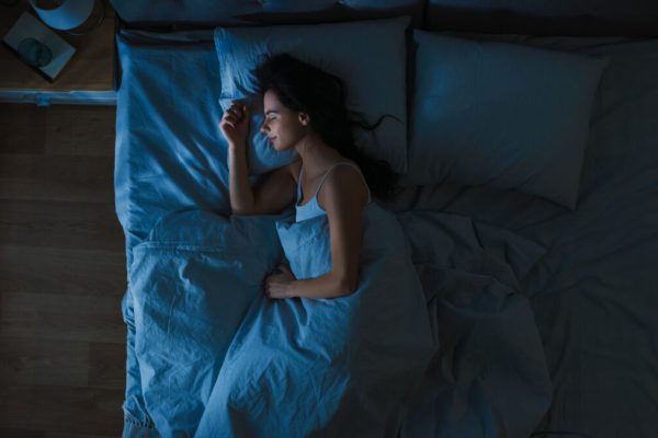 Top,View,Of,Beautiful,Young,Woman,Sleeping,Cozily,On,A