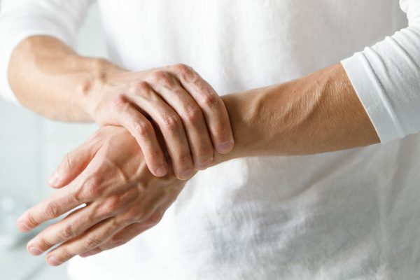 Closeup,Of,Male,Arms,Holding,His,Painful,Wrist,Caused,By