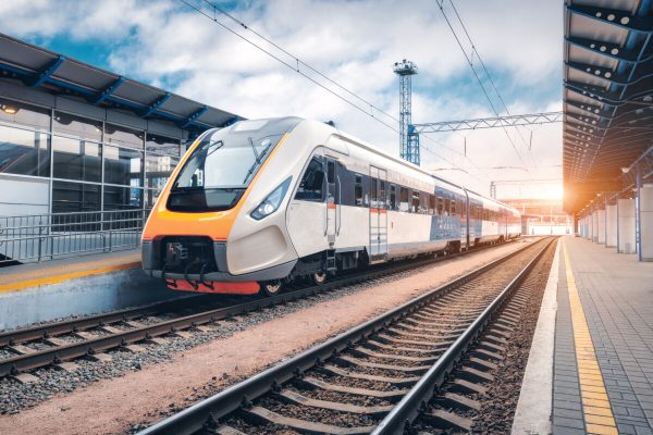 High,Speed,Train,On,The,Railway,Station,At,Sunset.,Industrial