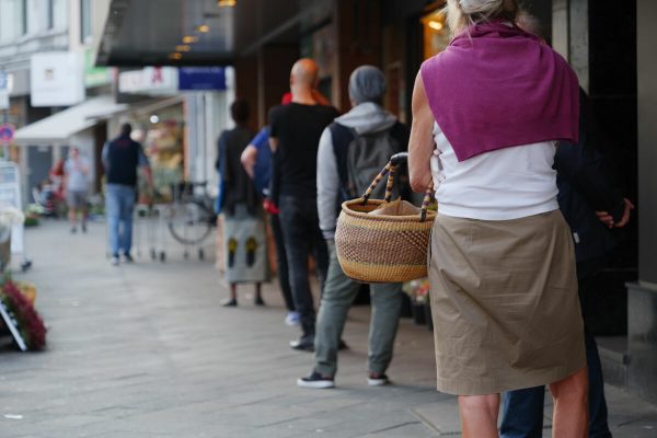 Low,Angle,And,Selected,Focus,,European,People,Queue,And,Wait