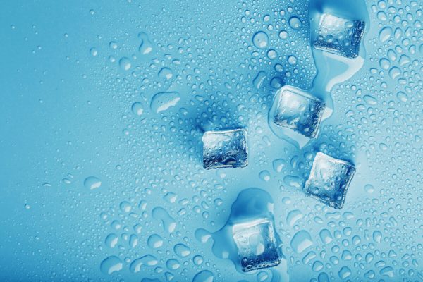 Ice,Cubes,With,Water,Drops,Scattered,On,A,Blue,Background,