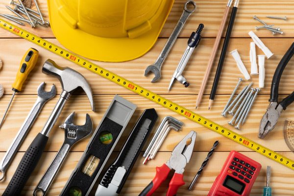 All,Tools,Supplies,Home,Construction,On,The,Wooden,Table,Background.