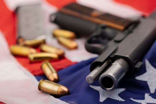 Automatic,Hand,Gun,With,Bullets,On,An,Usa,Flag,Background