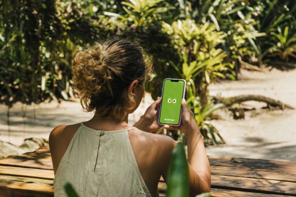 Girl,In,The,Park,Holding,A,Smartphone,With,Duolingo,Language-learning