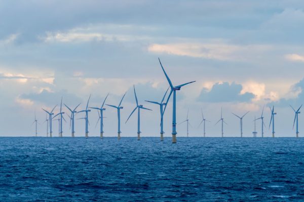 Offshore and Onshore Windmill farm Westermeerwind, Windmill park in the Netherlands with huge large wind turbines, group of windmills for renewable electric energy