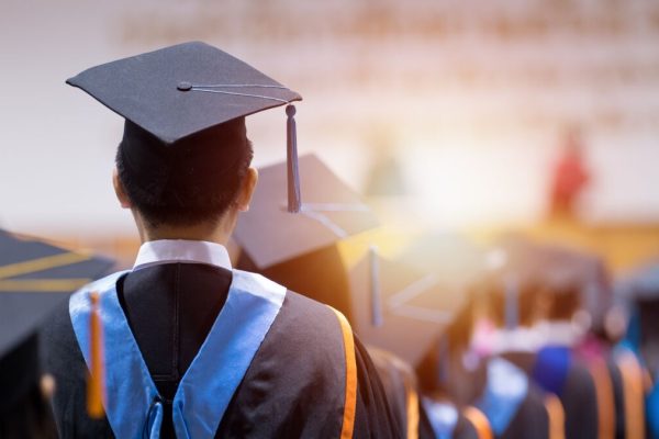 Rear,View,Of,University,Graduates,Wearing,Graduation,Gown,And,Cap