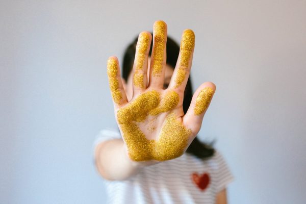 Unrecognizable,Young,Girl,Showing,Her,Palm,Hand,Covered,Of,Golden
