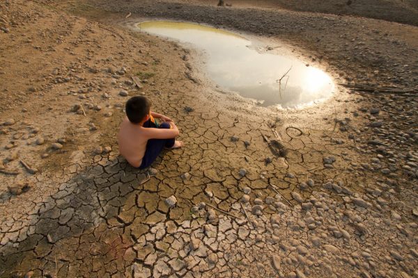 Water,Crisis,,Child,Sit,On,Cracked,Earth,Near,Drying,Water.