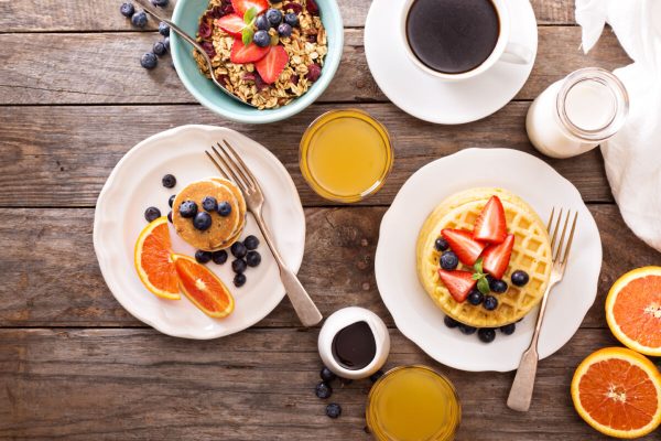 Breakfast,Table,With,Waffles,,Granola,And,Fresh,Berries