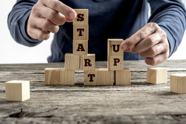 Front,View,Of,A,Businessman,Arranging,Wooden,Cubes,In,A