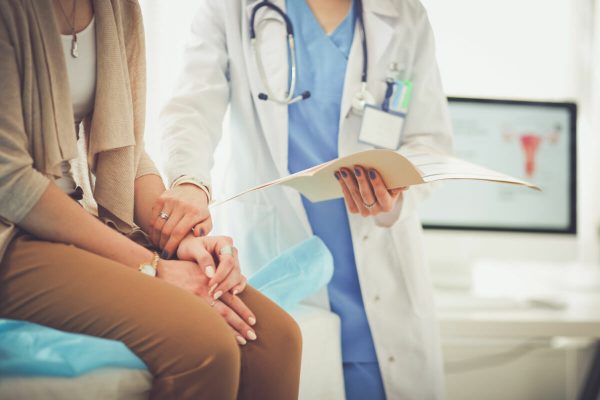 Doctor,And,Patient,Discussing,Something,While,Sitting,At,The,Table