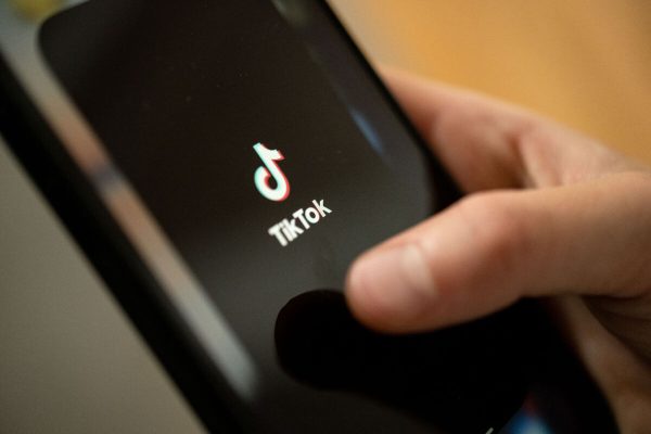 PRODUCTION - 11 July 2022, Baden-Wuerttemberg, Stuttgart: ILLUSTRATION - A teenager taps the TikTok logo on a smartphone. Photo: Marijan Murat/dpa