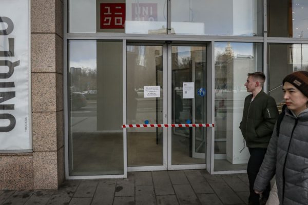 epa09860597 People walk past a closed Uniqlo store in Moscow, Russia, 30 March 2022. Japanese Fast Retailing Co., the operator of the Uniqlo clothing chain, suspended business operations in Russia as a result of sanctions imposed on the country by the international community in the wake of its military operation in Ukraine. The Japanese retailer opened its first store in Russia in 2010 and has 50 stores around the country.  EPA/YURI KOCHETKOV