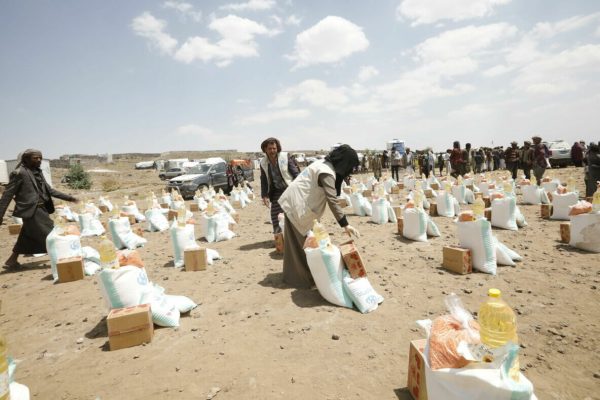 epa09498532 Emergency food aid, provided by a local relief agency, are prepared to be distributed to displaced Yemenis amid a heightened food insecurity, at a camp for Internally Displaced Persons (IDPs) on the outskirts of Sana'a, Yemen, 30 September 2021. International donors on 22 September pledged another 600 million US dollar for Yemen after the World Food Programme (WFP) warned that at least five million people in war-ridden Yemen are on the brink of starvation and another 16 million facing a critical lack of food over the coming weeks and months due to severe shortages of funding. The United Nations ranks Yemen as the worst humanitarian crisis in the world with an estimated 80 percent of its 29 million-population are reliant on humanitarian aid for survival now.  EPA/YAHYA ARHAB