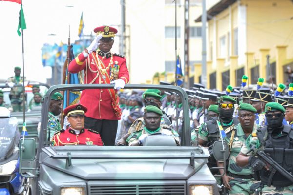 epa10840433 The leader of Gabon's military junta General Brice Oligui Nguema (top) reviews the troops after being sworn in as interim president in Libreville, Gabon, 04 September 2023. Nguema on 30 August led a coup that ousted President Ali Bongo Ondimba.  EPA/CHRIST DARCEL