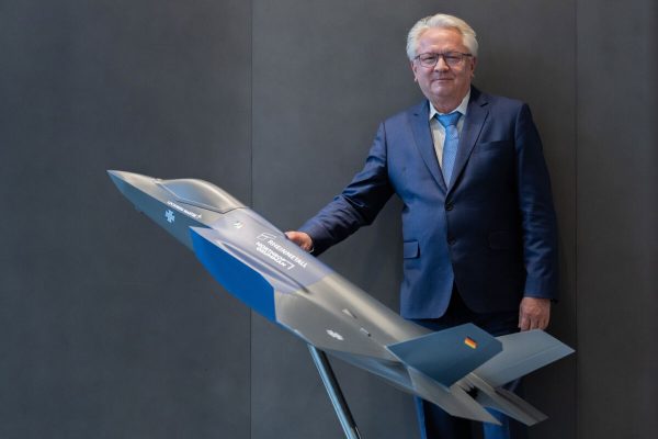 dpatop - 12 March 2025, North Rhine-Westphalia, Duesseldorf: Armin Papperger, CEO of Rheinmetall AG, stands behind a model of a Lockheed Martin F-35A at Group headquarters after the annual press conference. In cooperation with Northrop Grumman, Rheinmetall supplies the center fuselage section. Photo: Rolf Vennenbernd/dpa