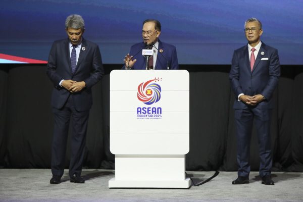 May 27, 2025, Kuala Lumpur, Malaysia: Malaysia's Prime Minister Anwar Ibrahim (center) seen with Mohamad Hasan the Malaysia foreign minister (Left) and Tengku Zafrul Aziz Minister of Investment, Trade and Industry of Malaysia (right) while giving a speech for the 46th ASEAN Summit and related summit during a press conference at Kuala Lumpur Convention Centre. (Credit Image: © Faris Hadziq/SOPA Images via ZUMA Press Wire)